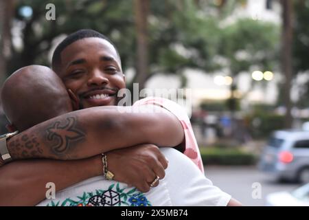 USA, Louisiana, Smiling gay couple embracing in city Stock Photo