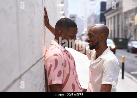 USA, Louisiana, Smiling gay couple flirting in city Stock Photo