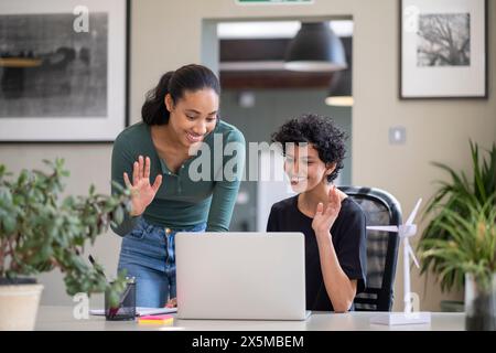 Young engineers having video call on laptop in office Stock Photo