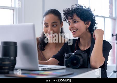 Female photographers using laptop Stock Photo