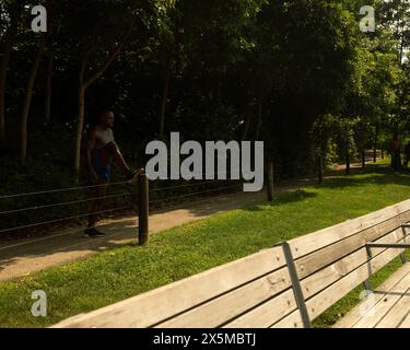 Athletic man stretching in park Stock Photo