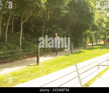 Athletic man jogging in park Stock Photo