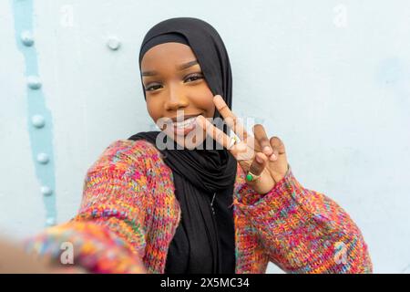Portrait of smiling young woman wearing hijab Stock Photo
