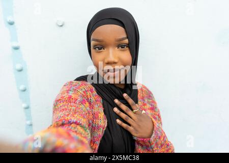 Portrait of smiling young woman wearing hijab Stock Photo