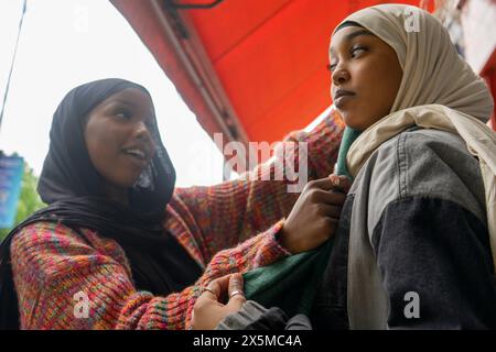 Young woman adjusting friends hijab Stock Photo