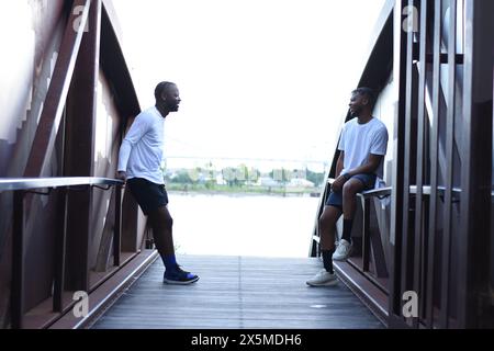 USA, Louisiana, Smiling gay couple on bridge Stock Photo