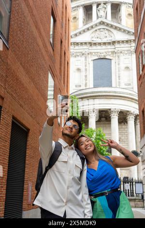 Mixed Race couple taking selfies Stock Photo - Alamy