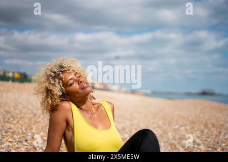 Naked woman sunbathing on beach Stock Photo - Alamy