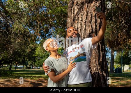 Couple taking selfie in park Stock Photo