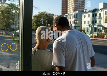 Young couple using smart phone in city Stock Photo