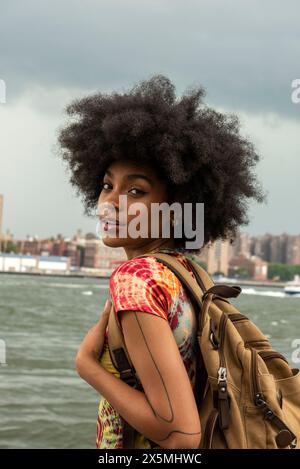 USA, New York City, Portrait of young woman with backpack Stock Photo