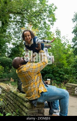 Father playing with daughter in park Stock Photo
