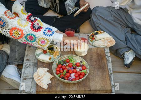 Friends sharing snacks on patio Stock Photo