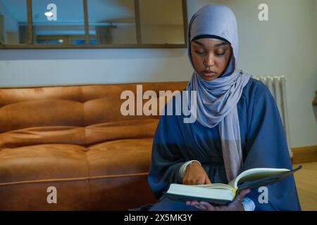 Muslim woman praying at home Stock Photo