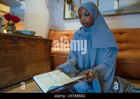 Muslim woman praying at home Stock Photo