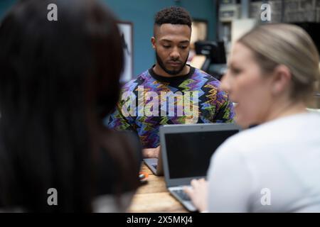 Creative professionals working together in cafeteria Stock Photo