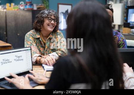 Creative professionals working together in cafeteria Stock Photo