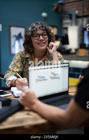 Creative professionals working together in cafeteria Stock Photo
