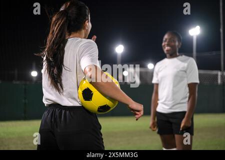Female soccer players in playing field Stock Photo