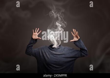 Woman head going up in smoke showing burnout syndrome or mental illness. Creative concept of overheating head or burning out Stock Photo