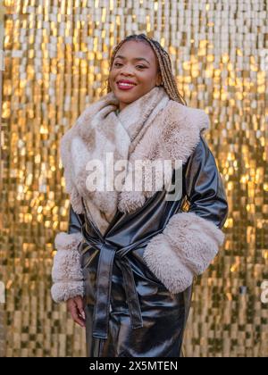 Portrait of smiling young woman in fur coat Stock Photo