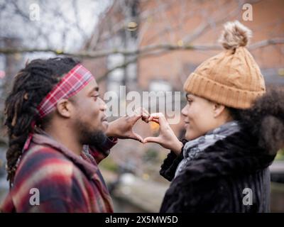 Couple making heart sign Stock Photo