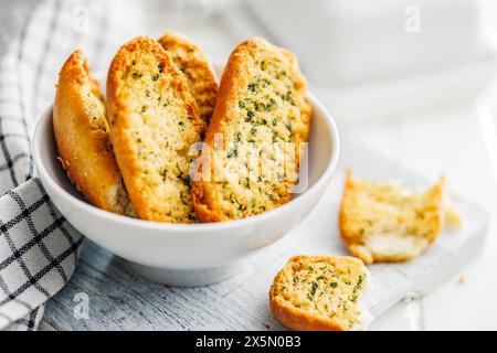 Garlic crisp bread Slices Topped With Herbs in a bowl. Stock Photo