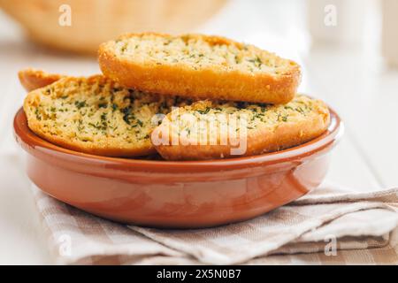 Garlic crisp bread Slices Topped With Herbs in a bowl. Stock Photo