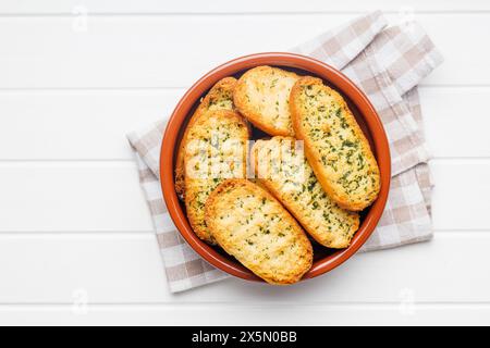 Garlic crisp bread Slices Topped With Herbs in a bowl. Top view. Stock Photo