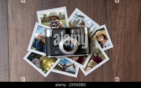 Top view of Old photo camera surrounded by photographs of women in different places on a dark wooden table Stock Photo