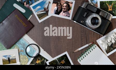 Top view of Couple photographs, passports, old camera, map and notebook on a dark wooden table Stock Photo