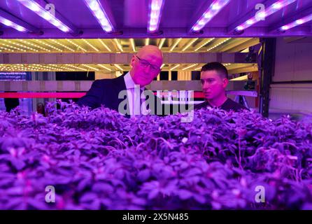 First Minister John Swinney and co-founder Dave Scott (right) look at the innovative vertical farm growth towers at the Crop Research Centre, during a visit to Intelligent Growth Solutions in Dundee. Picture date: Friday May 10, 2024. Stock Photo