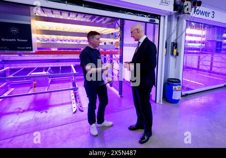 Co-founder Dave Scott (left) and First Minister John Swinney look at the innovative vertical farm growth towers at the Crop Research Centre, during a visit to Intelligent Growth Solutions in Dundee. Picture date: Friday May 10, 2024. Stock Photo