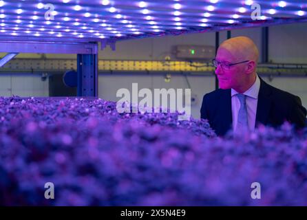 First Minister John Swinney takes a closer look at the innovative vertical farm growth towers at the Crop Research Centre, during a visit to Intelligent Growth Solutions in Dundee. Picture date: Friday May 10, 2024. Stock Photo