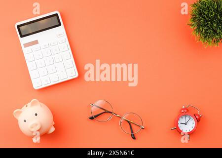 Piggy bank with calculators office desk top view. Stock Photo