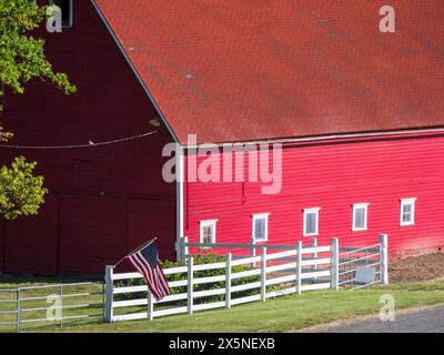 USA, Washington State, Palouse. Close-up of a red barn with an American flag on a white fence. (Editorial Use Only) Stock Photo