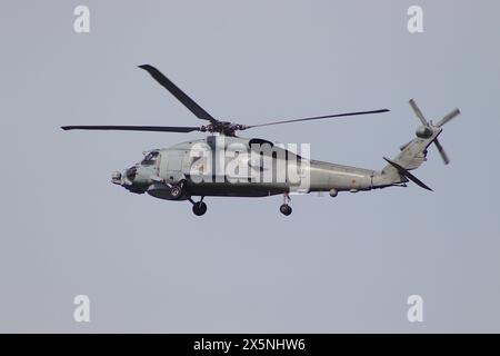 Spanish Navy winch training at Ferrol Naval Base (Arsenal of Ferrol), as Sikorsky SH-60 Seahawk helicopter registration 01-1011, circles the harbour. Stock Photo