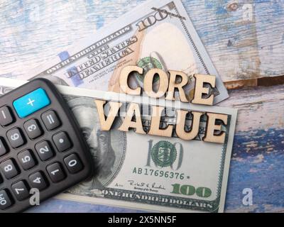 Too view calculator,banknotes and wooden word with text CORE VALUE on wooden background. Business concept. Stock Photo