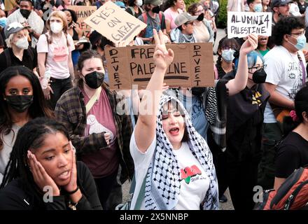 April 26, 2024, Atlanta, Georgia, USA: A young woman appears to be in total dismay as a woman next ot her puts up a peace symbol with her fingers, apart of a large crowd of protesters consisting of faculty members and students at Emory University in Atlanta participate in a rally and march held on the university's campus. Signed saying: 'EYES ON GAZA', 'ALUMNI 4 PALESTINE' and 'DIVEST - FREE PALESTINE - DIVEST'. The protest was held in solidarity with university students across the U.S. demanding that their respective schools divest resources that contribute to Israel's ongoing siege of the Ga Stock Photo