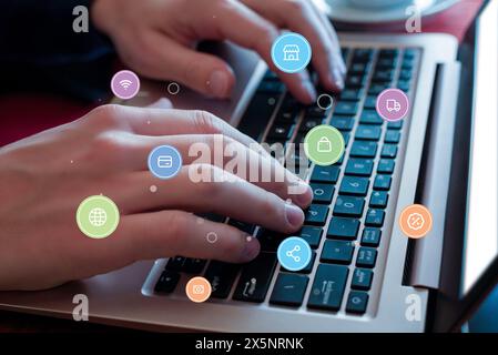 Hands typing on laptop keyboard with levitating icons: credit card, shop, money, discount. Concept of seamless online shopping experience Stock Photo