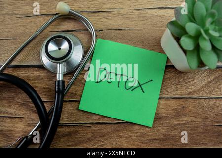 Concept of Detox write on sticky notes isolated on Wooden Table. Stock Photo