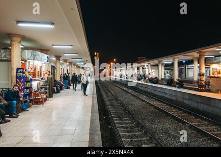 Passengers wait on the platform at Luxor Railway Station, Egypt, at night Stock Photo