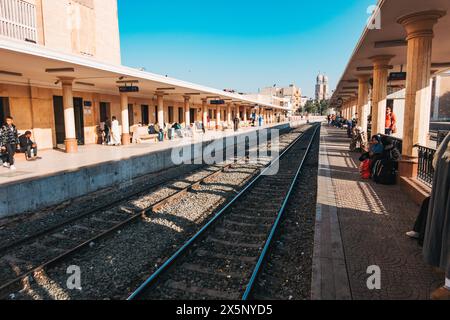 Passengers wait on the train platform at Luxor Railways Station in Egypt Stock Photo