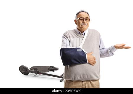 Unhappy mature man with a broken arm injured from an electric scooter isolated on white background Stock Photo