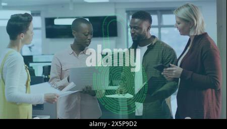 Diverse team discussing over digital interface in office Stock Photo