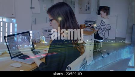 Two Caucasian women, friends, are working on laptops in office Stock Photo