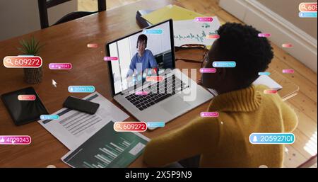 African American woman and Asian man are partners, working on laptops Stock Photo