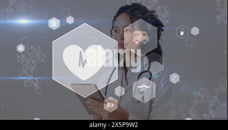 Image of medical icons over african american female doctor using tablet Stock Photo