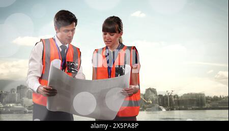 Image of white dots over caucasian female and male engineers Stock Photo