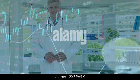 Caucasian senior colleague/father figure in white coat holding stethoscope Stock Photo